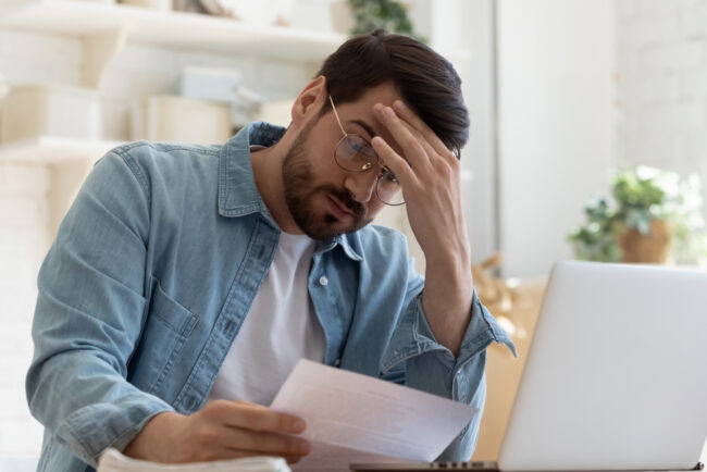 Upset,Frustrated,Young,Man,Reading,Bad,News,In,Postal,Mail