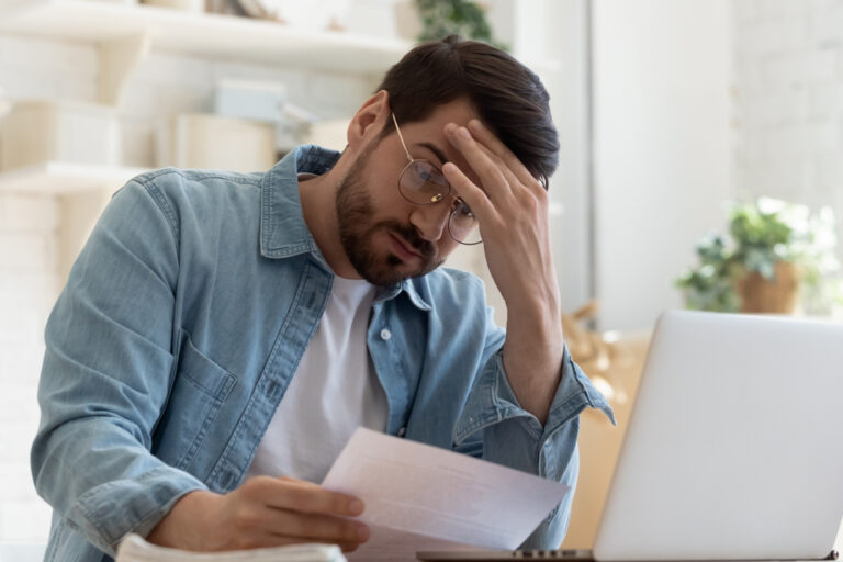 Upset,Frustrated,Young,Man,Reading,Bad,News,In,Postal,Mail
