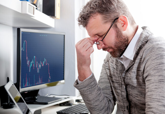 Depressed,Investor,Analyzing,Crisis,Stock,Market,With,Charts,On,Laptop
