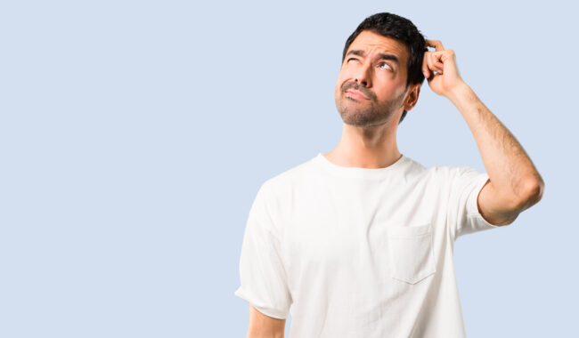 Young,Man,With,White,Shirt,Having,Doubts,And,With,Confuse