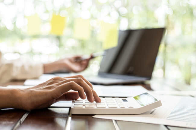 Close-up,Of,A,Businesswoman,Using,A,White,Calculator,,A,Financial