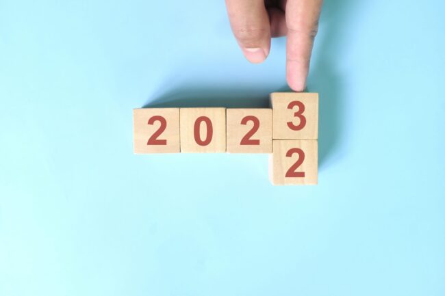 Hand,Changing,Year,2022,To,2023,In,Wooden,Blocks,Cubes