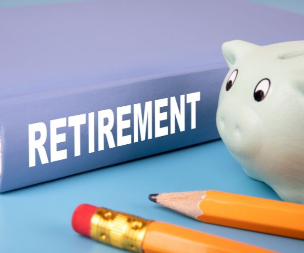 piggy bank, pencils, and a retirement book
