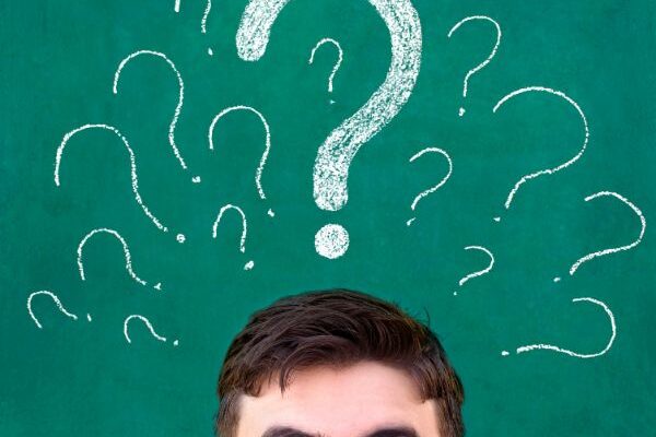 man thinking with questions marks above his head
