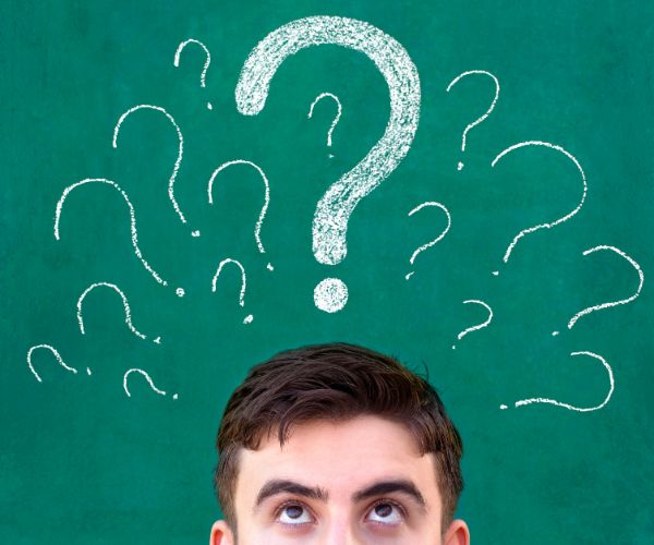 man thinking with questions marks above his head