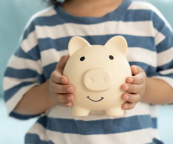 child holding a piggy bank
